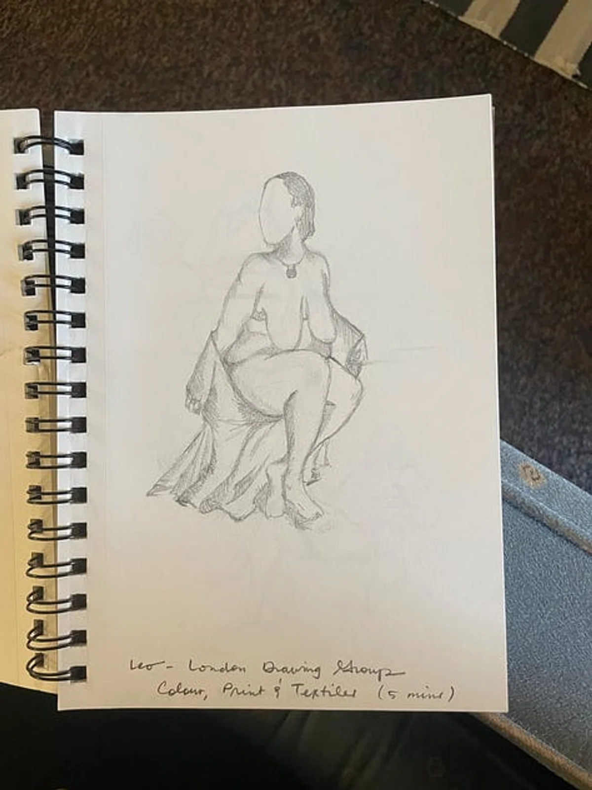 Drawing of a nude female figure.